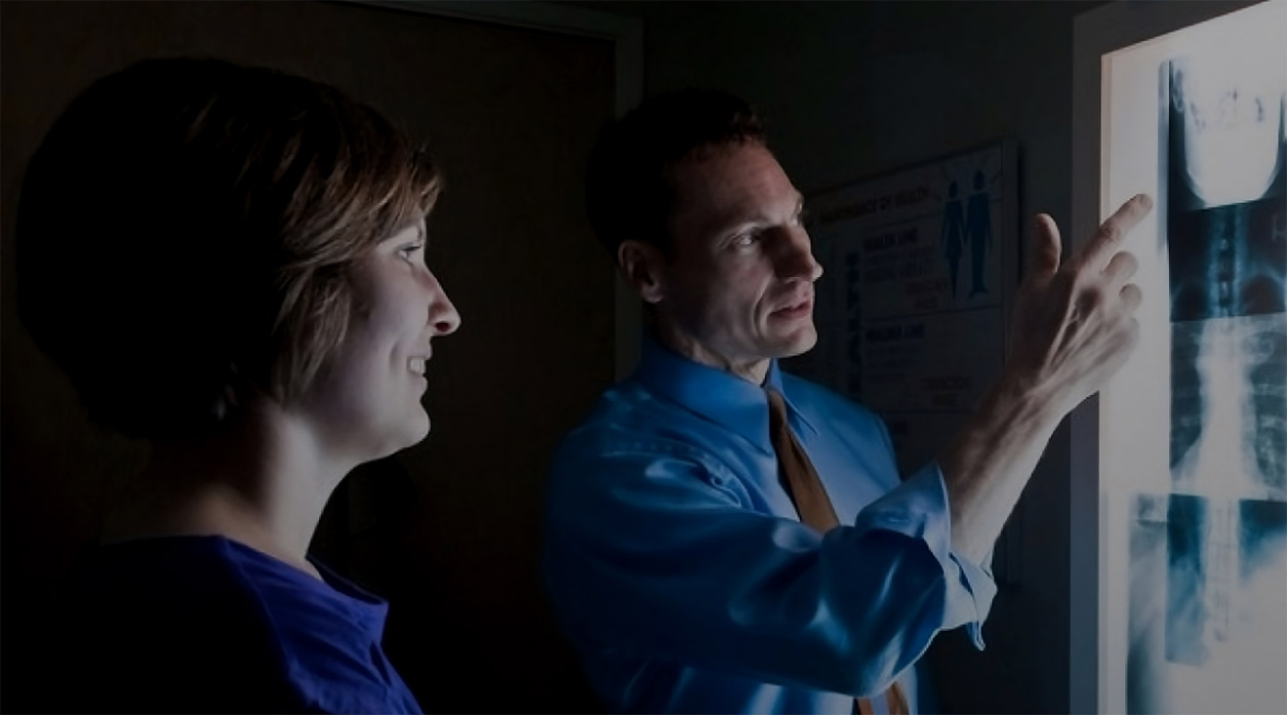 Dr. Shelley examines spinal x-ray
